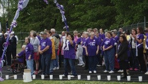 JONATHAN ROWE | DAILY NEWS SURVIVOR LAP: On Friday evening, survivors lined up on the Washington High School track to walk the first lap of Relay for Life, the survivor lap. 