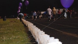 JONATHAN ROWE | DAILY NEWS LUMINARIES: Friday night, participants in Relay for Life lined the track with luminaries, or lanterns, and hope balloons that were sold for people to dedicate to the memory of a lost loved one or survivor.  