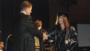 JONATHAN ROWE | DAILY NEWS DIPLOMA: Arts and Sciences graduate Jessa Rose Robertson walked across the WHS auditorium stage on Thursday evening to receive her degree from BCCC President Barbara Tansey. Pictured is Robertson shaking hands with BCCC Board of Trustees Chairman Russell Smith. 