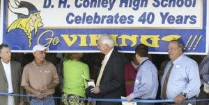 BENJIE FORREST FOR THE KIDS: Benjie Forrest (center) attended the ribbon cutting ceremony for D.H. Conley High School’s 40th anniversary in 2011. He has played an active role in schools across the eastern part of the state. 