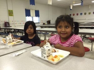 CAROLINE HUDSON|DAILY NEWS FAMILY AFFAIR: Pictured from the right are Eva Miranda, 6, and Adriana Miranda, 5. Care-O-World provides a bus route to bring many of the children to eat at Eastern Elementary School in Washington.