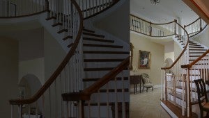 JONATHAN ROWE | DAILY NEWS GRAND ENTRANCE: A sweeping staircase, leading to a balcony atop the great room, two bedrooms and a guest suite, marks the foyer of Liles’ home. 