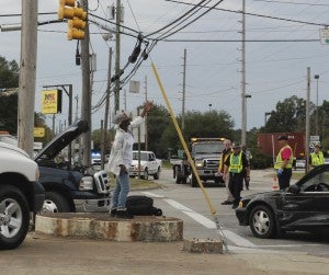 CAROLINE HUDSON | DAILY NEWS Pictured is a local woman singing and praising God following the four-car wreck at an intersection in Washington on Friday, 